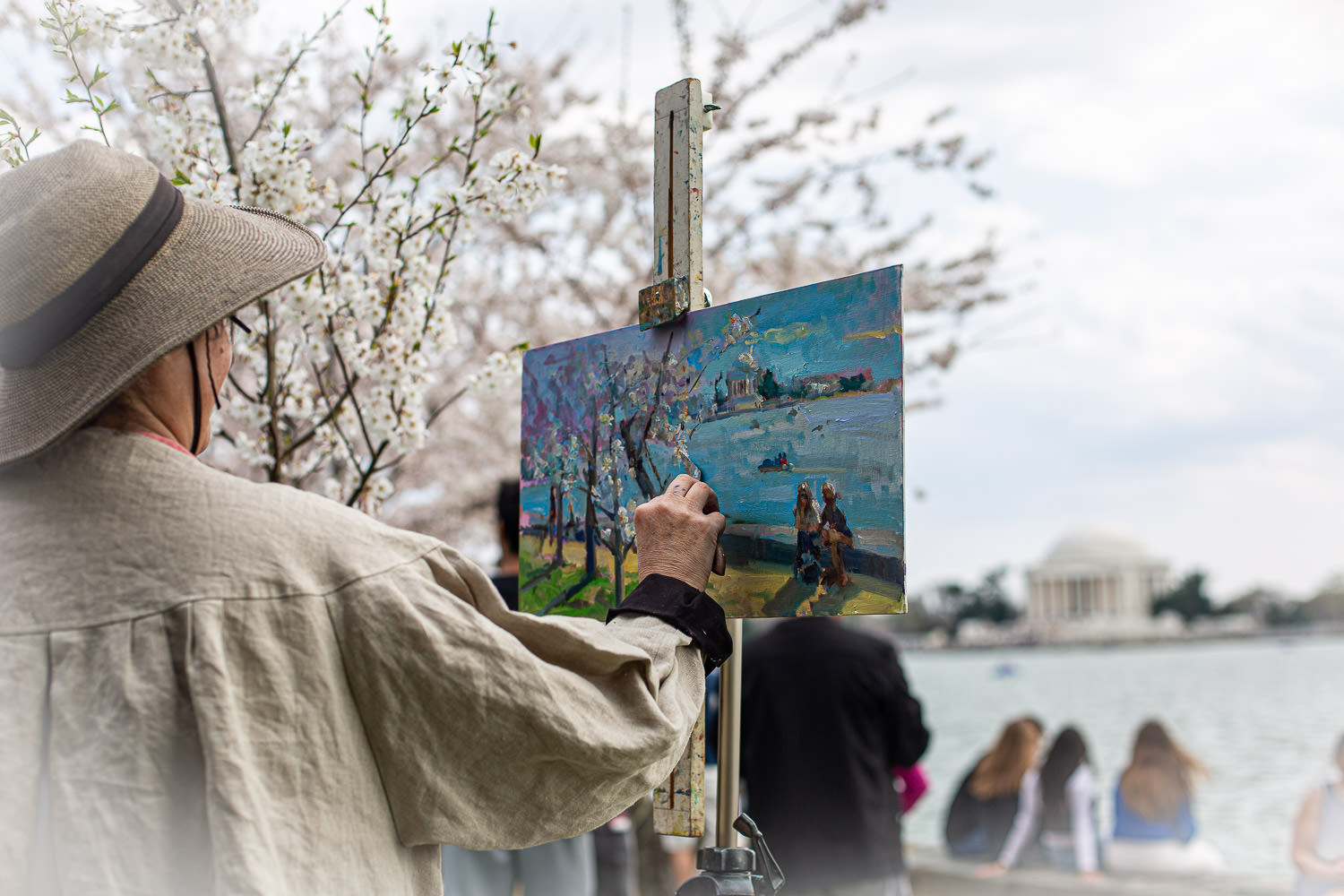Artist painting cherry blossoms in plein air