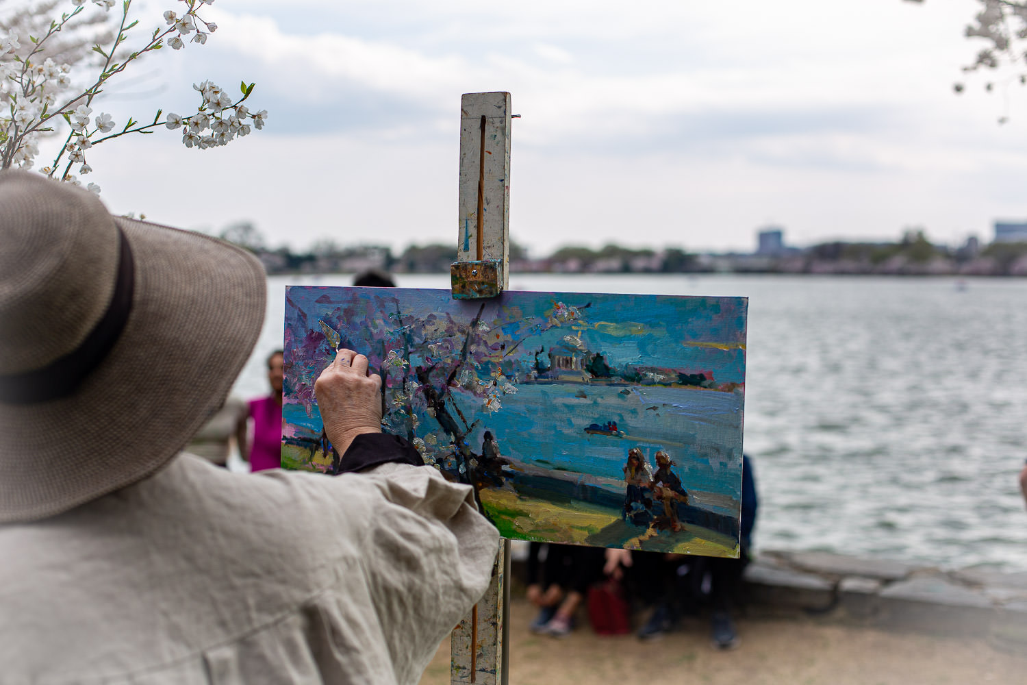 Close-up of artist painting cherry blossoms