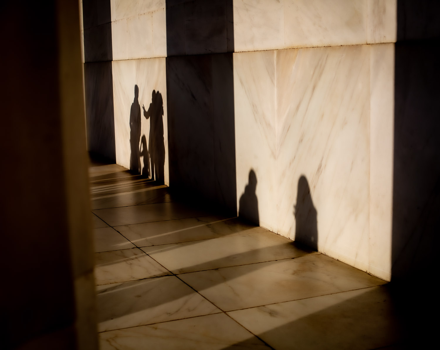 Evening shadows stretching across a memorial