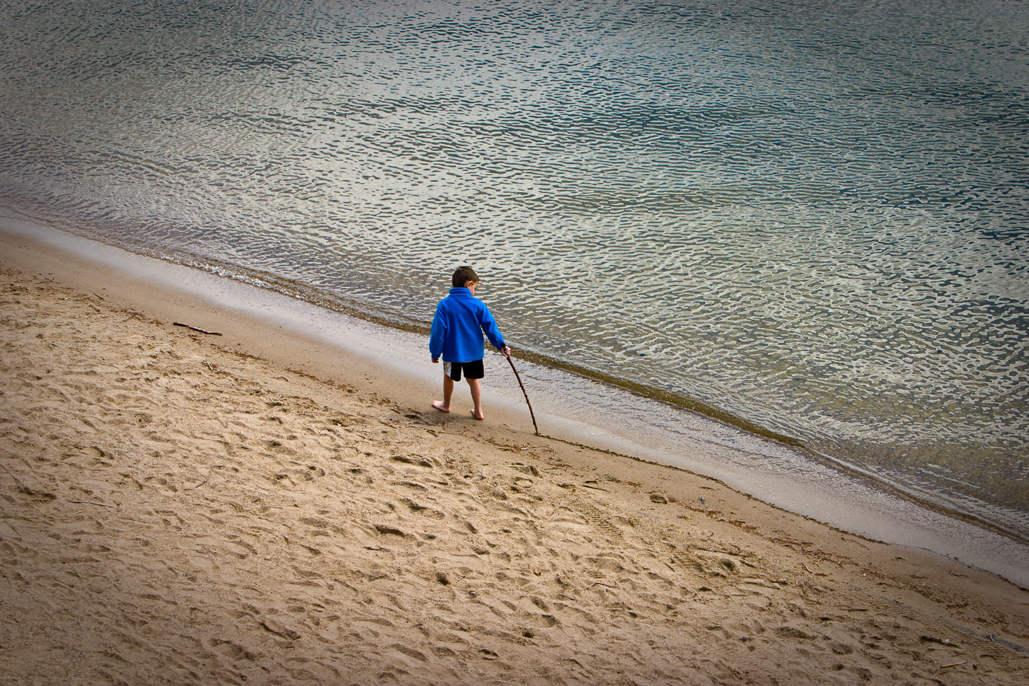 Child playing on a sandy beach